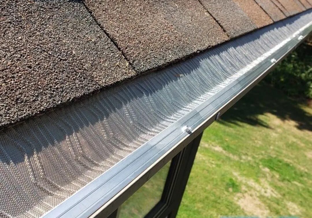 A picture of a gutter on a roof with the JB's Incorporated logo on the bottom of the image