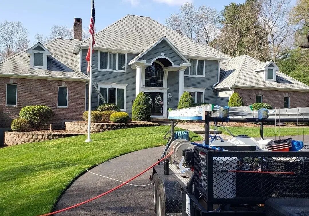 A large house with a trailer parked in front of it.